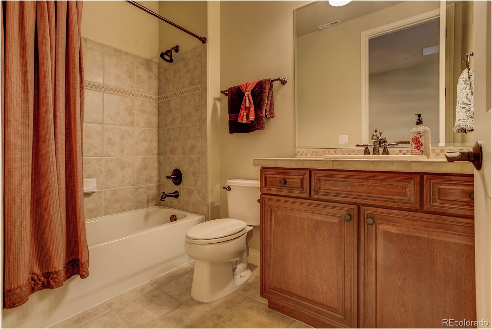 4363 Chateau Ridge Lane Castle Rock, CO 80108 - Photo 27 of 32 a bathroom with a sink a toilet and shower