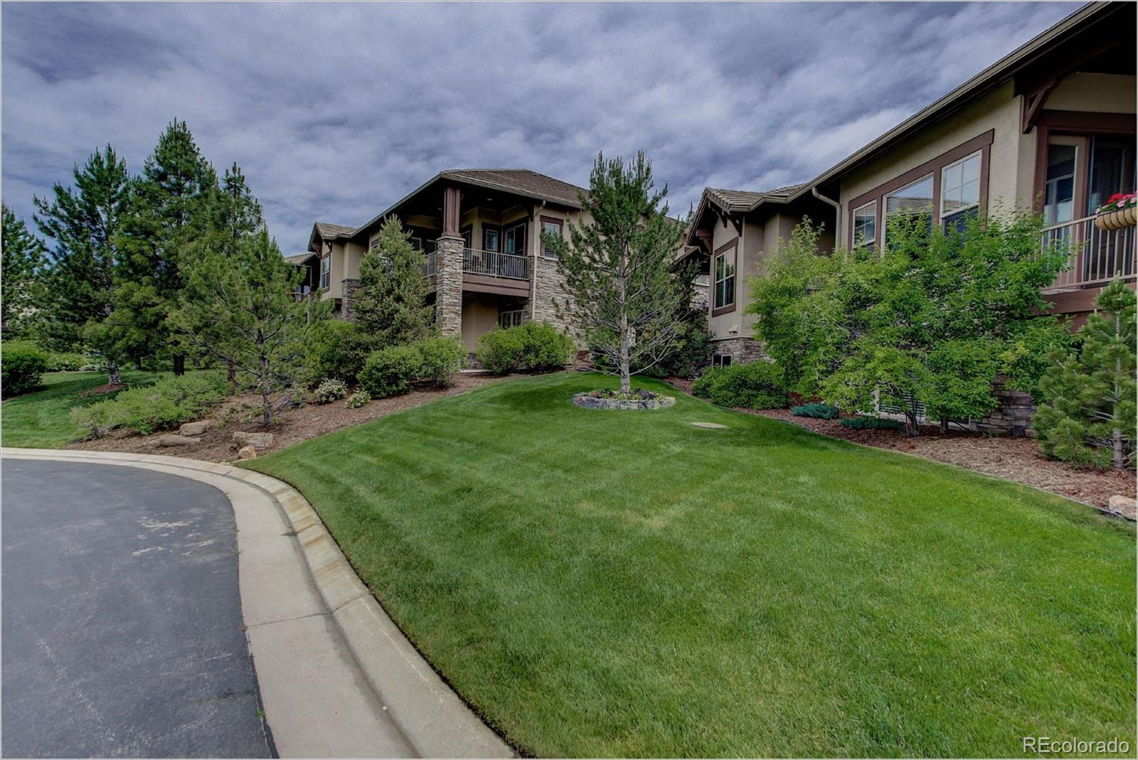 4363 Chateau Ridge Lane Castle Rock, CO 80108 - Photo 30 of 32 a front view of a house with a yard