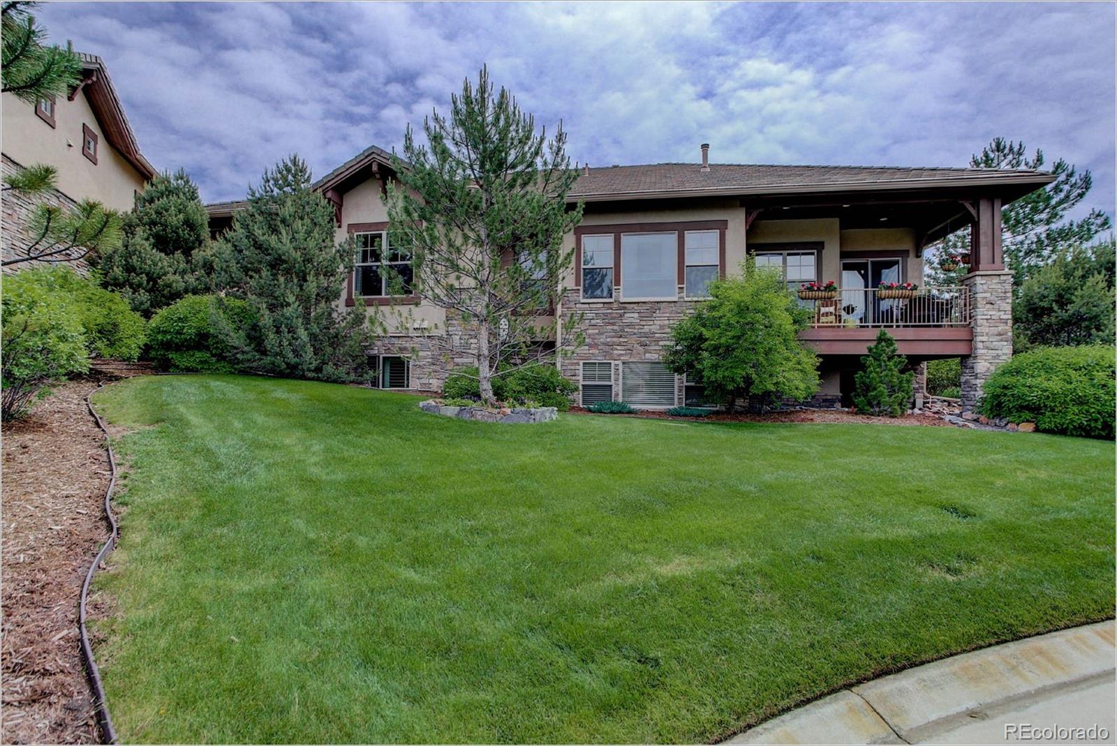 4363 Chateau Ridge Lane Castle Rock, CO 80108 - Photo 31 of 32 a view of a house with a yard