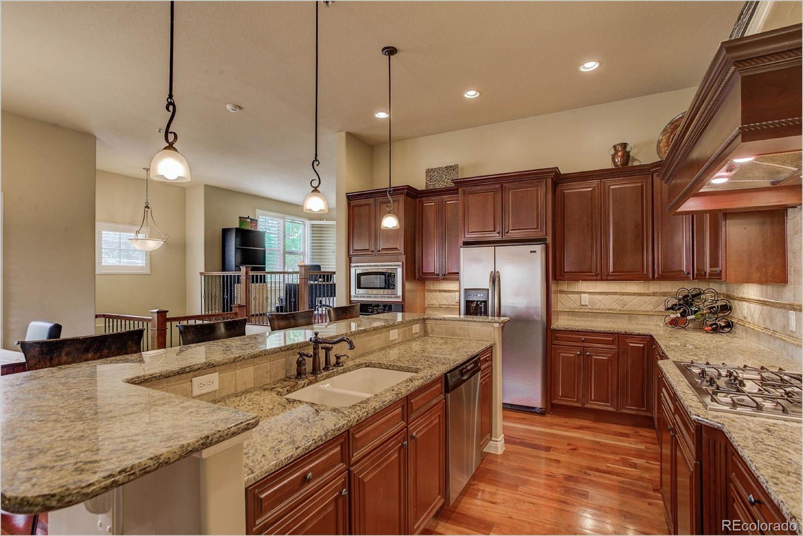 4363 Chateau Ridge Lane Castle Rock, CO 80108 - Photo 5 of 32 a kitchen with stainless steel appliances granite countertop a sink stove and refrigerator