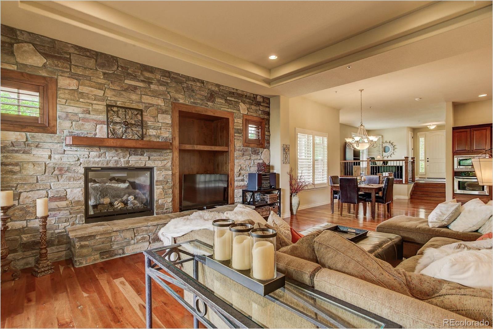 4363 Chateau Ridge Lane Castle Rock, CO 80108 - Photo 8 of 32 a living room with furniture and a fireplace