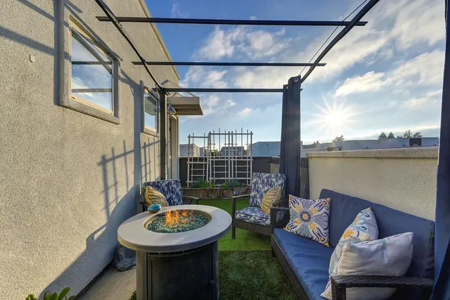 a backyard of a house with outdoor seating