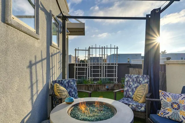 a view of a porch with furniture and a garden