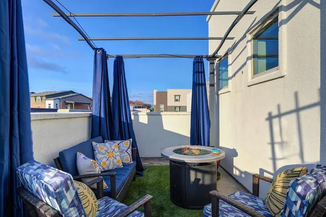 a front view of a house with outdoor seating