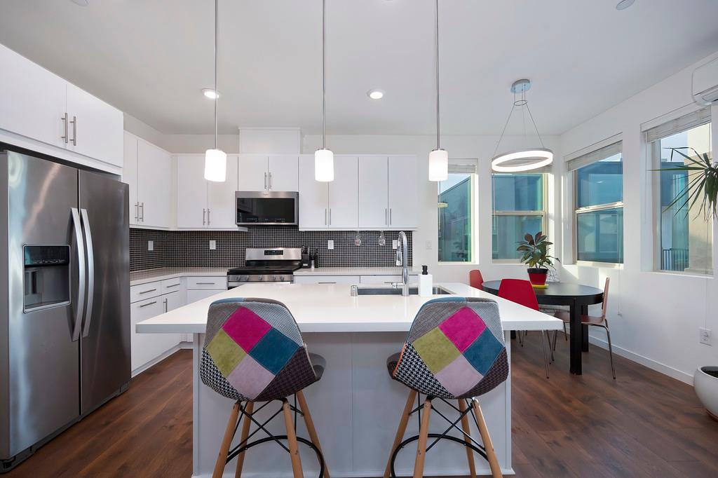 216 Box Lane Sacramento, CA 95818 - Photo 2 of 37 a kitchen with cabinets and chairs