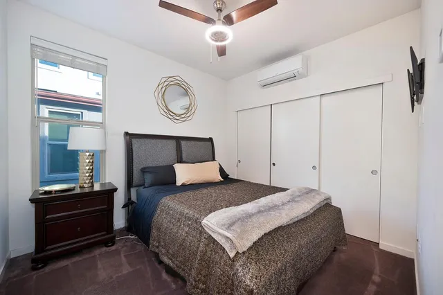 a bedroom with a bed and a chandelier