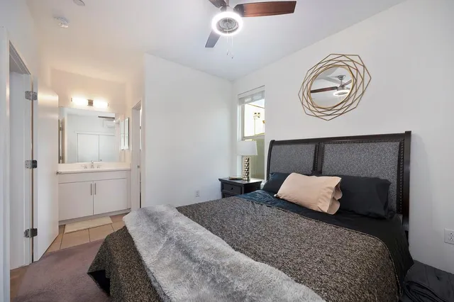 a bedroom with a bed and a window