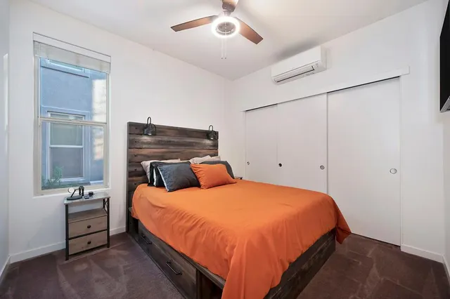 a bed room with a bed and a night stand