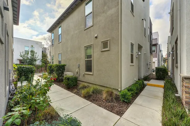 a view of a pathway both side of the house