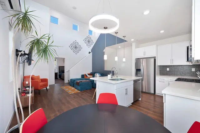 a large kitchen with a table and chairs