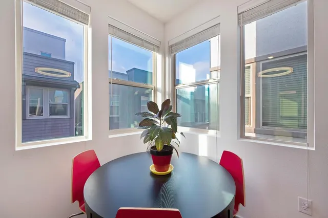 a view of a dining room with a table and chairs