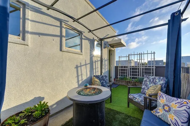 a view of a porch with furniture and garden