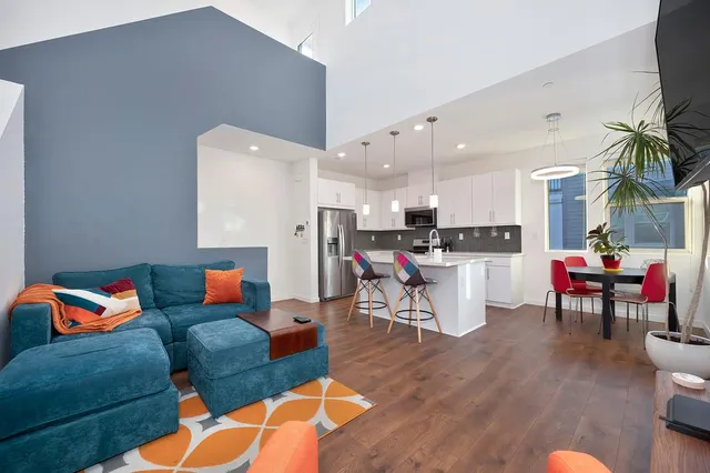 a living room with furniture and kitchen view