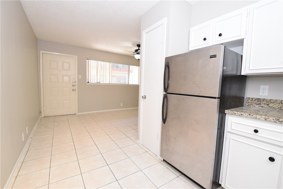 2404 Longview Street, Unit 103 Austin, TX 78705 - Photo 9 of 12 a kitchen with a refrigerator and a stove