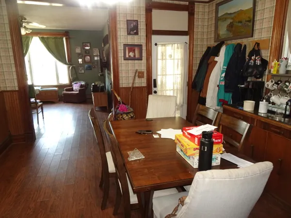 a view of a dining room with furniture and wooden floor