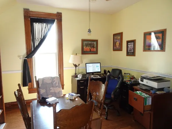a view of a workspace with furniture and a window