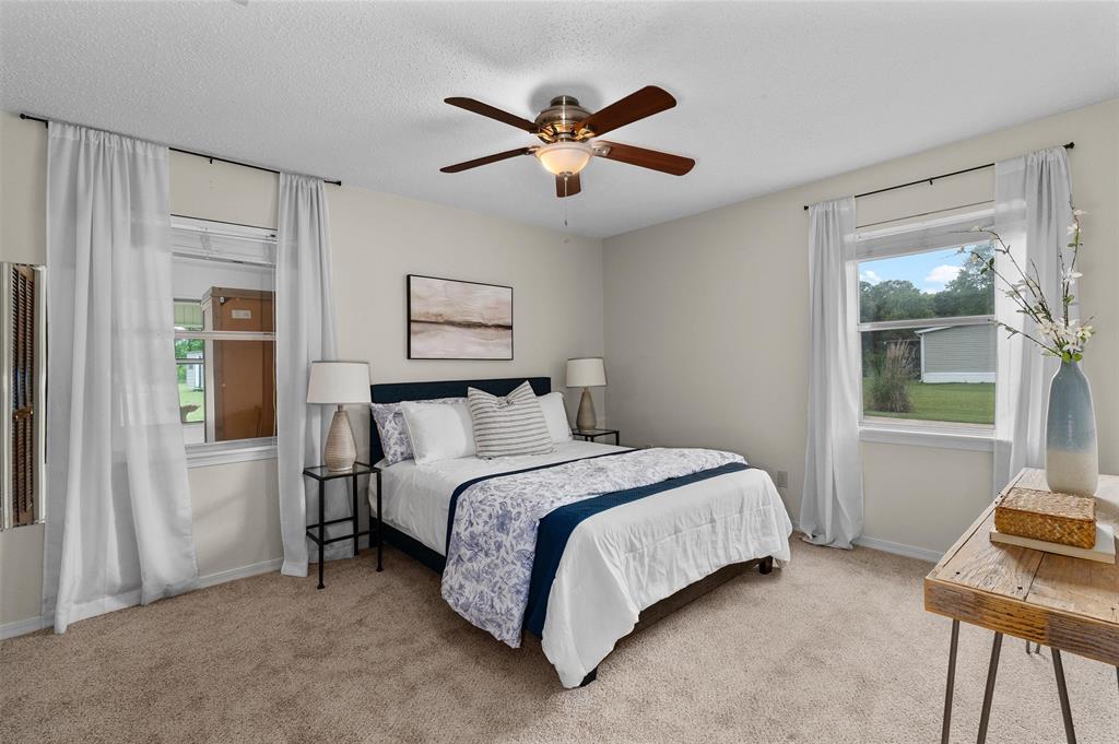 927 Stonewall-Preston Road Stonewall, LA 71078 - Photo 17 of 28 a bed room with a bed and a window