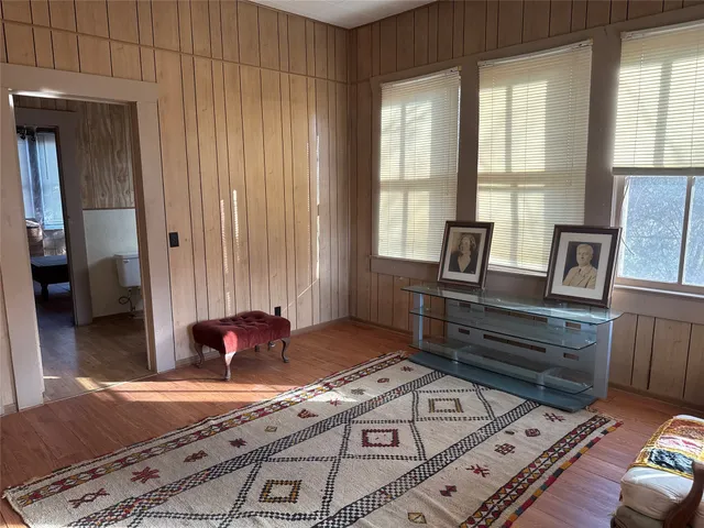 a living room with a bed furniture and a window
