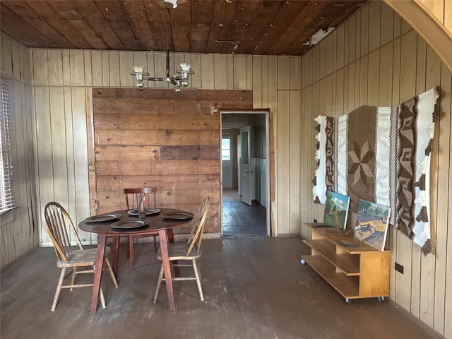 a dining room with furniture and a chandelier