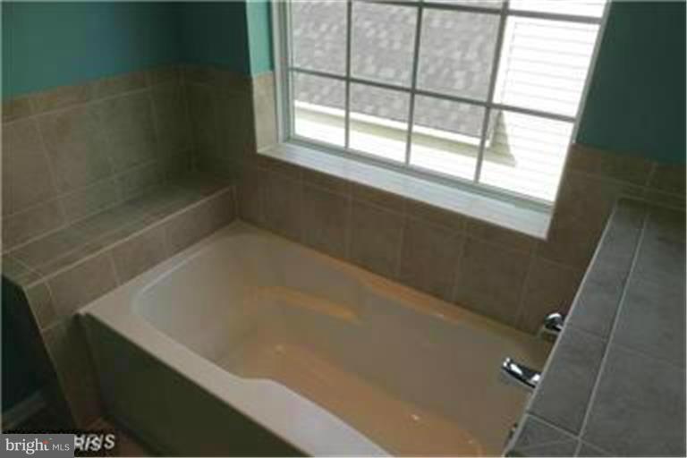 5952 Tyler Road Deale, MD 20751 - Photo 14 of 21 a bath tub sitting in a bathroom next to a window