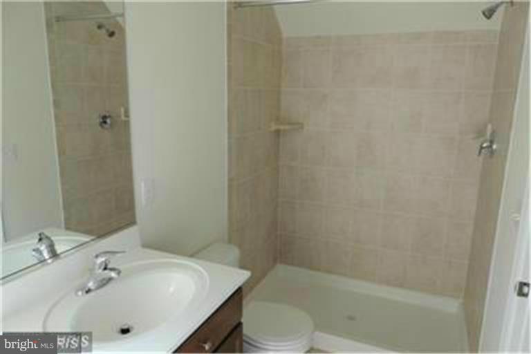 5952 Tyler Road Deale, MD 20751 - Photo 17 of 21 a bathroom with a sink a toilet and shower