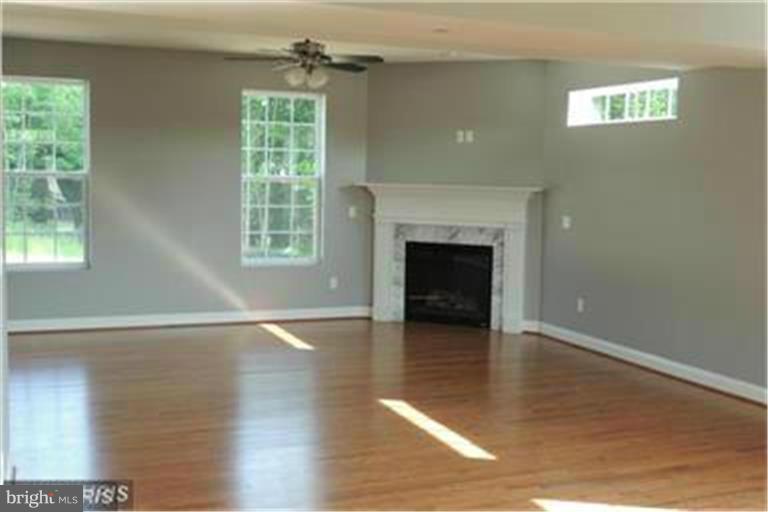 5952 Tyler Road Deale, MD 20751 - Photo 3 of 21 a view of an empty room with wooden floor and a window