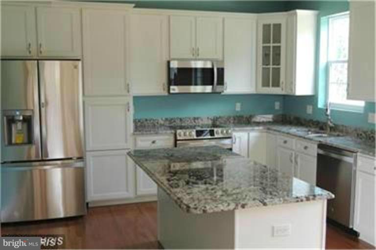 5952 Tyler Road Deale, MD 20751 - Photo 6 of 21 a kitchen with stainless steel appliances granite countertop a sink a microwave counter space and cabinets