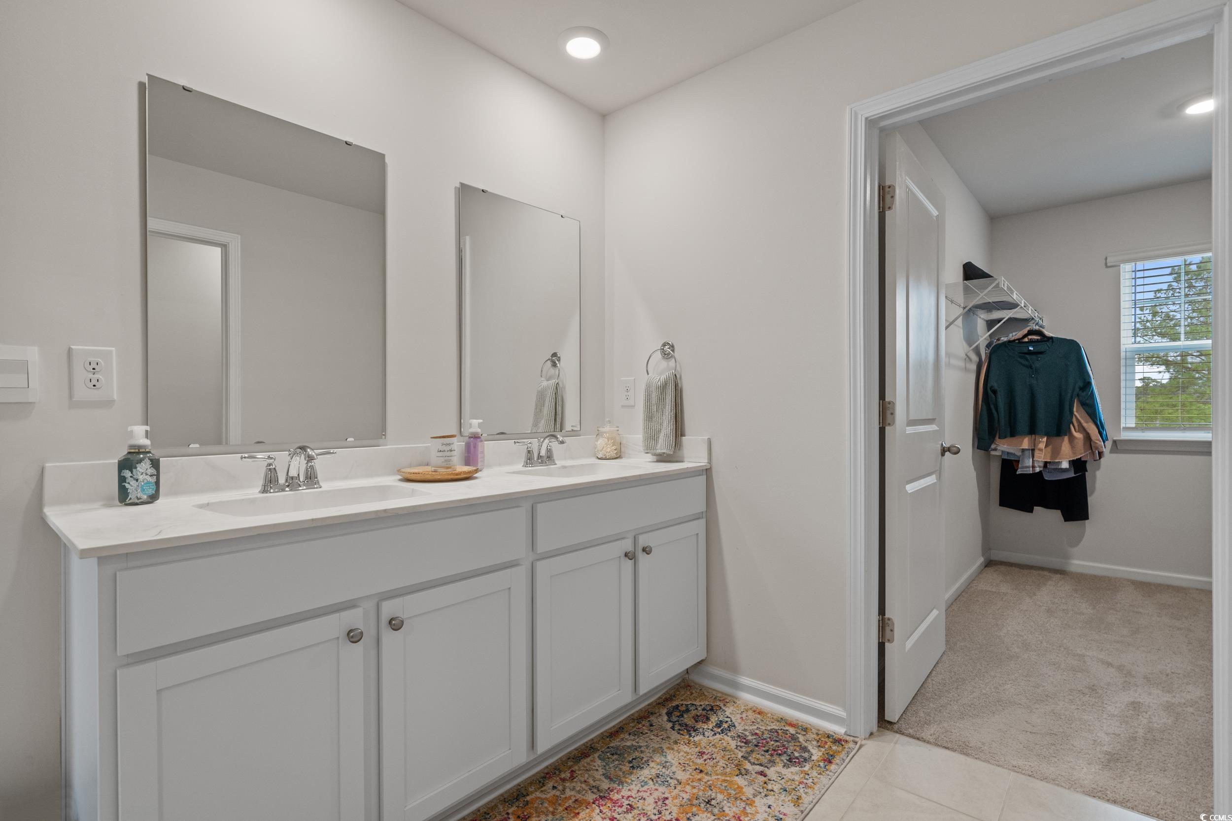 3343 Bells Lake Circle Longs, SC 29568 - Photo 18 of 40 Bathroom with double vanity, light colored carpet, and light tile patterned flooring