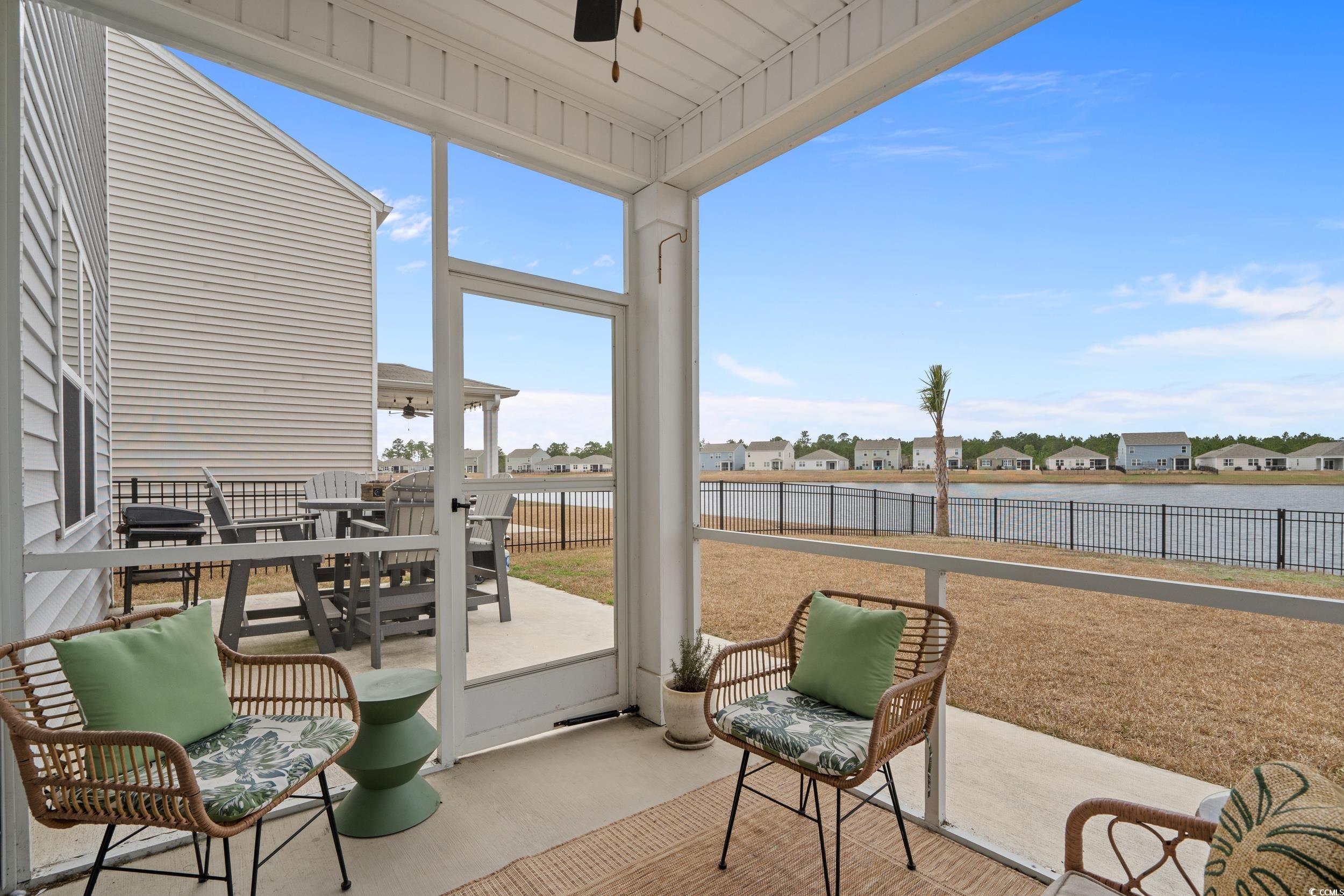 3343 Bells Lake Circle Longs, SC 29568 - Photo 25 of 40 Sunroom with a residential view, a water view, ceiling fan, and a patio area