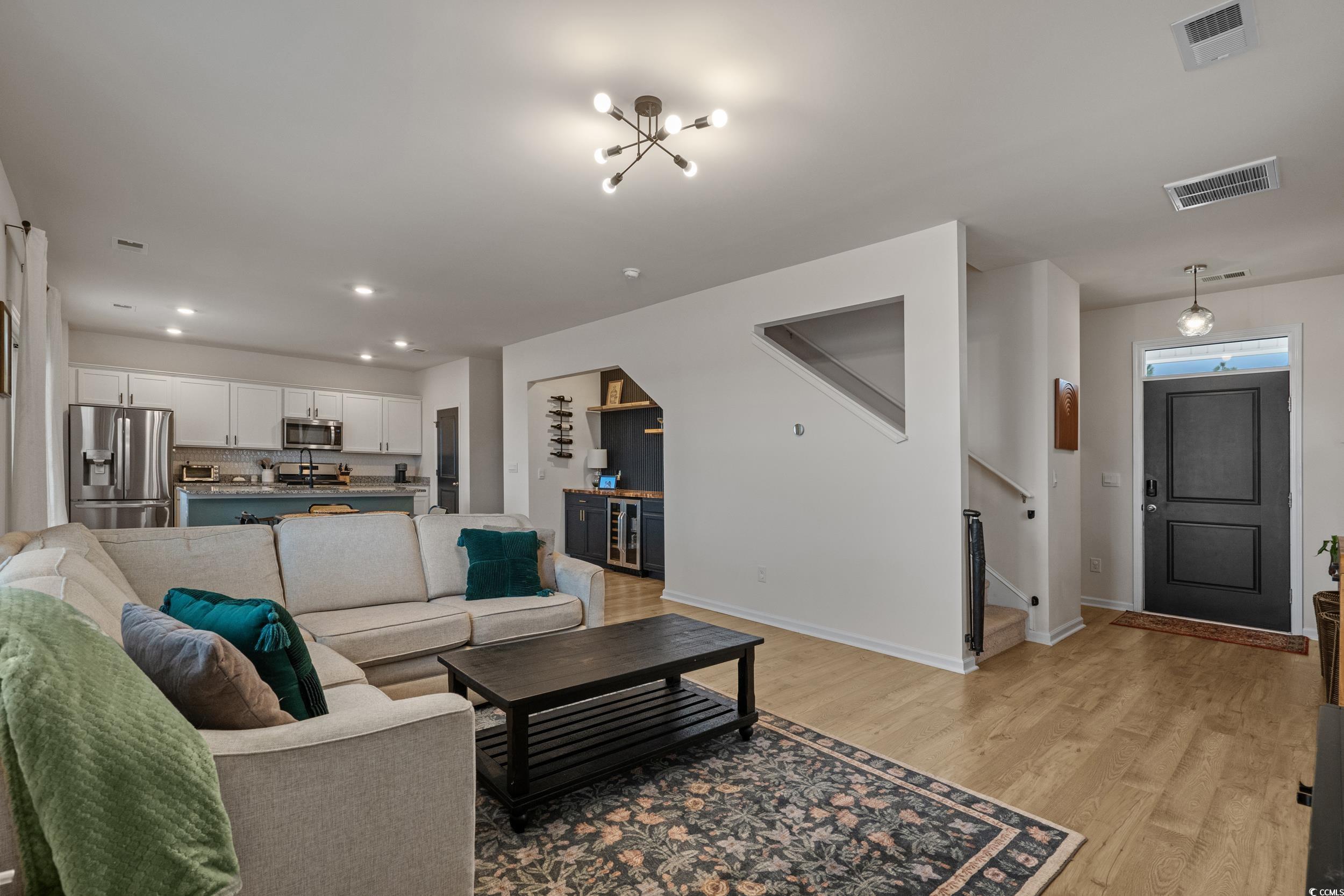 3343 Bells Lake Circle Longs, SC 29568 - Photo 7 of 40 Living area featuring light wood finished floors, recessed lighting, and beverage cooler
