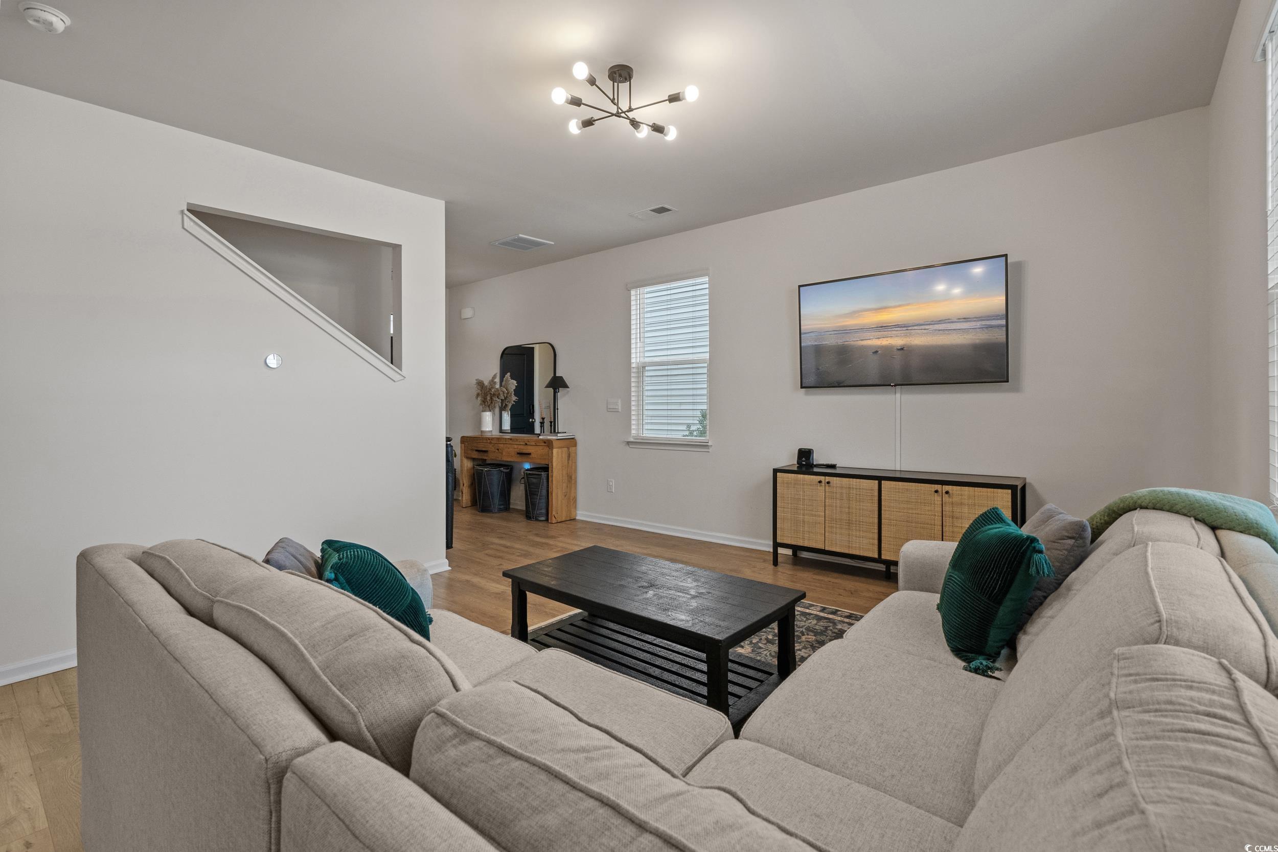 3343 Bells Lake Circle Longs, SC 29568 - Photo 8 of 40 Living area featuring light wood finished floors and a chandelier