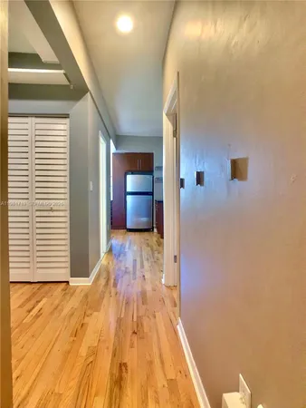 a view of hallway with wooden floor
