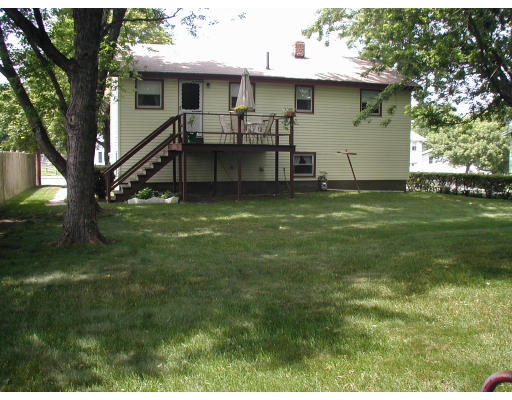 55 Summit Street Salem, MA 01970 - Photo 3 of 8 a backyard of a house with table and chairs