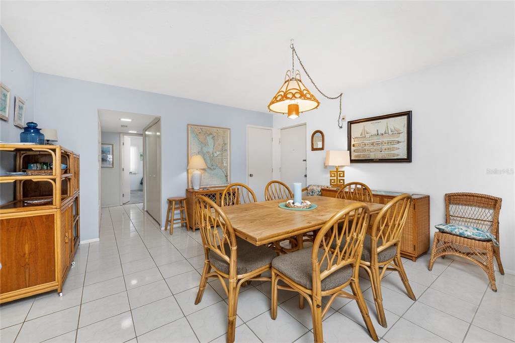 2955 North Beach Road, Unit B614 Englewood, FL 34223 - Photo 16 of 67 a view of a dining room with furniture and a table