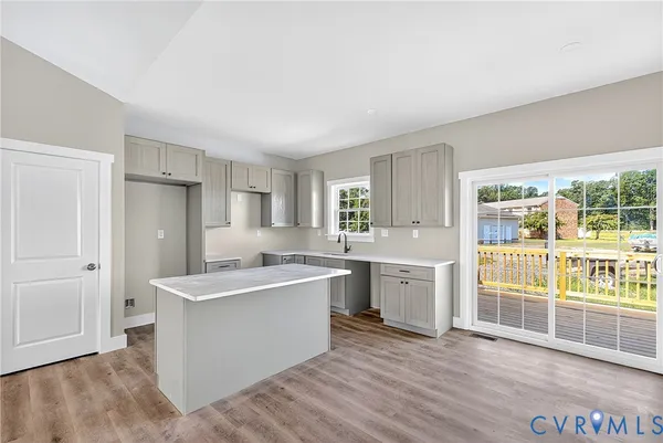 a view of a kitchen with a sink a refrigerator and window