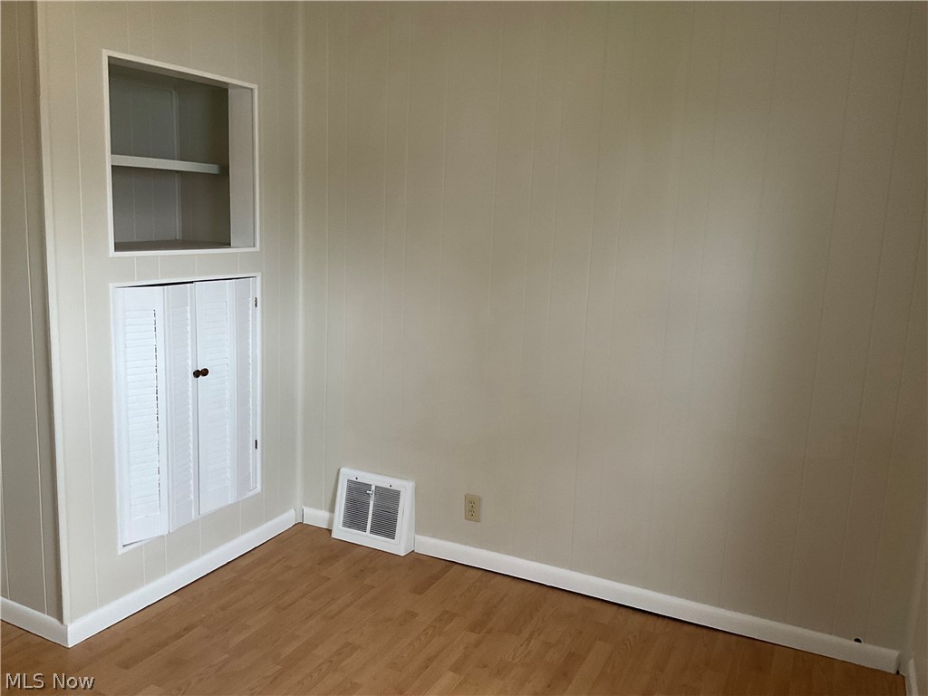 3475 South Turner Road Canfield, OH 44406 - Photo 16 of 33 Spare room with built in shelves and dark hardwood / wood-style flooring