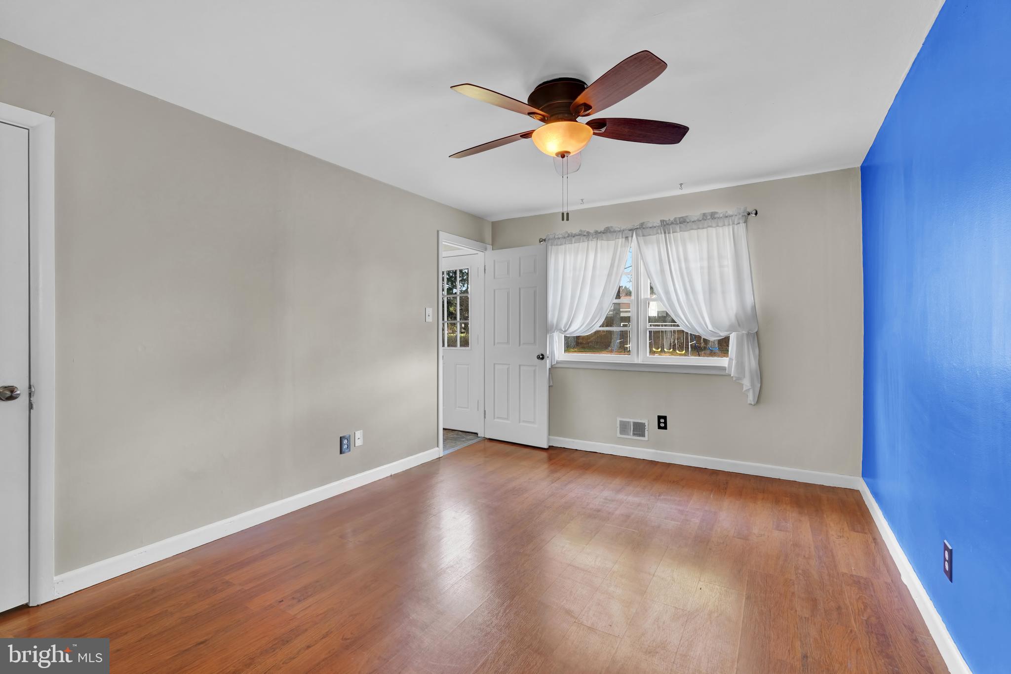 2370 Sycamore Road York, PA 17408 - Photo 12 of 24 an empty room with wooden floor chandelier fan and windows