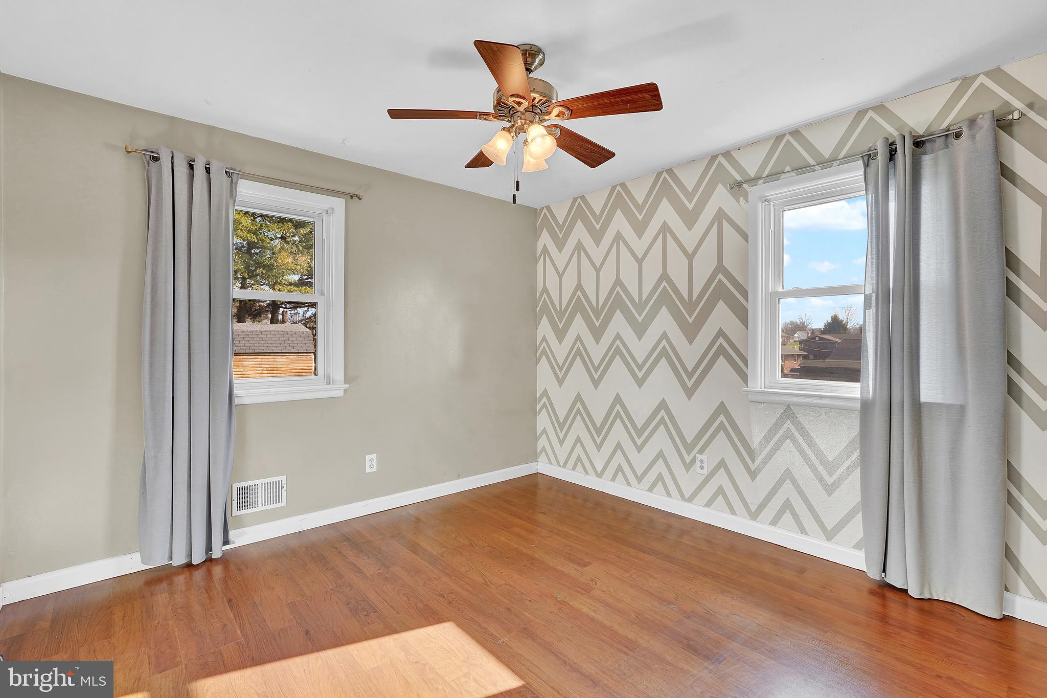 2370 Sycamore Road York, PA 17408 - Photo 15 of 24 a view of wooden floor and a chandelier fan in a room