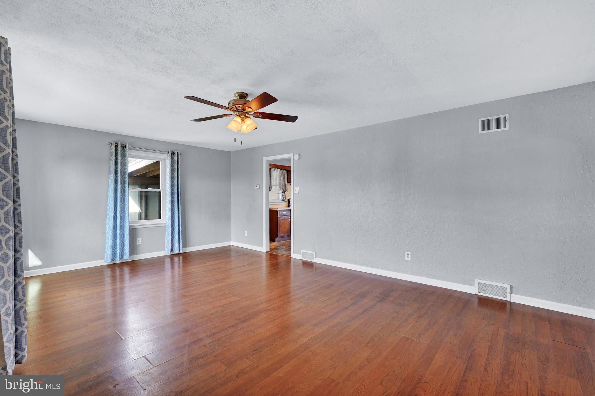 2370 Sycamore Road York, PA 17408 - Photo 6 of 24 a view of an empty room with window and wooden floor