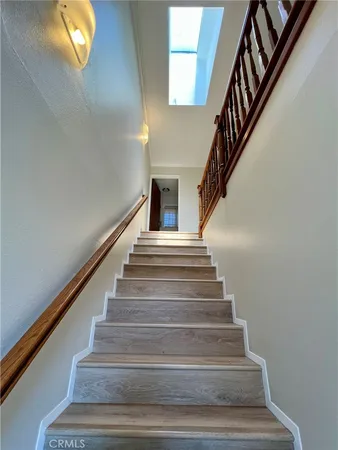 a living room with furniture tv and a floor to ceiling window