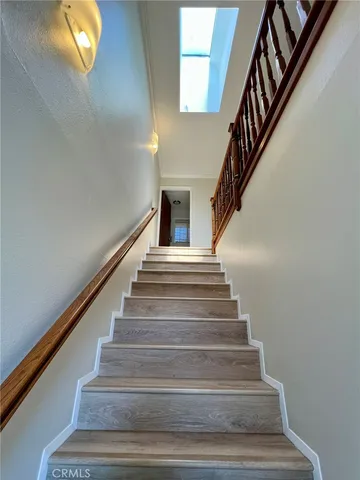 a living room with furniture tv and a floor to ceiling window
