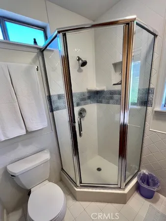 a view of a balcony with wooden floor and fence