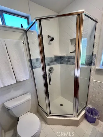 a view of a balcony with wooden floor and fence