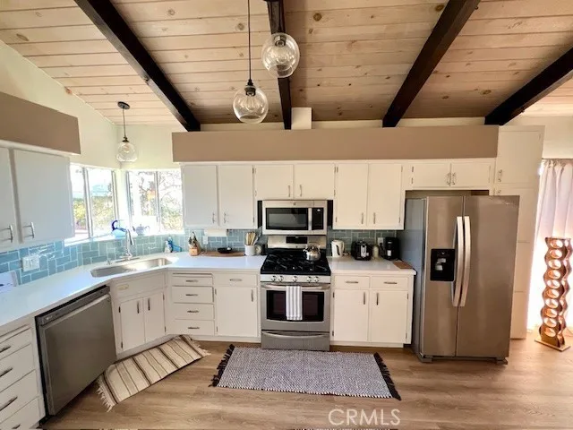 a living room with furniture a flat screen tv and a large window