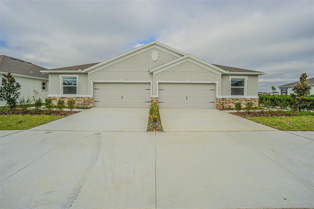 a view of garage yard and front view of a house