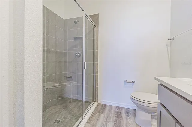 a bathroom with a toilet and a shower