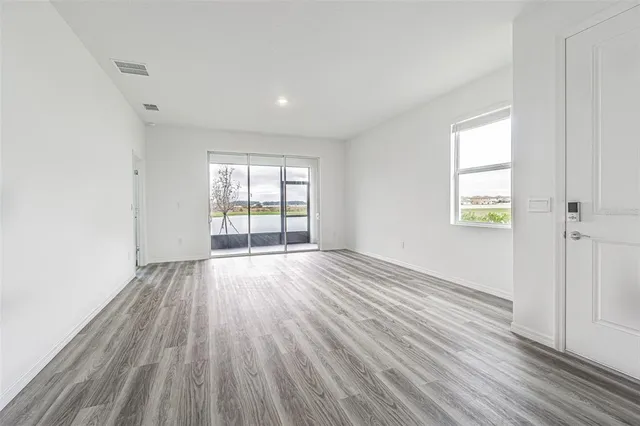 a view of kitchen with granite countertop cabinets and wooden floor