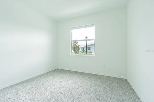 a bathroom with a sink toilet and window