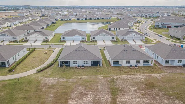 an aerial view of residential houses with outdoor space