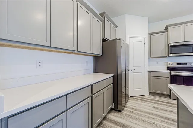 a kitchen with a sink and a refrigerator